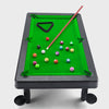 Miniature pool table with balls and a cue on a white background